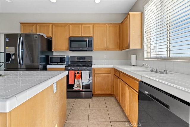 9179 Ravenswood Ave, Hesperia, CA 92344 - kitchen with tile countertops, stainless steel microwave, gas stove, black dishwasher, and refrigerator with ice dispenser
