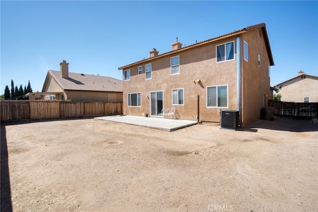 rear view of property with a patio and central AC unit