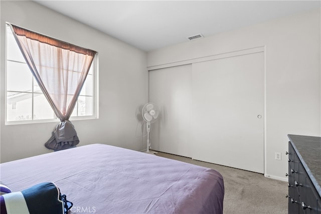 carpeted bedroom featuring a closet