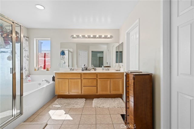 bathroom with tile patterned flooring, vanity, and shower with separate bathtub