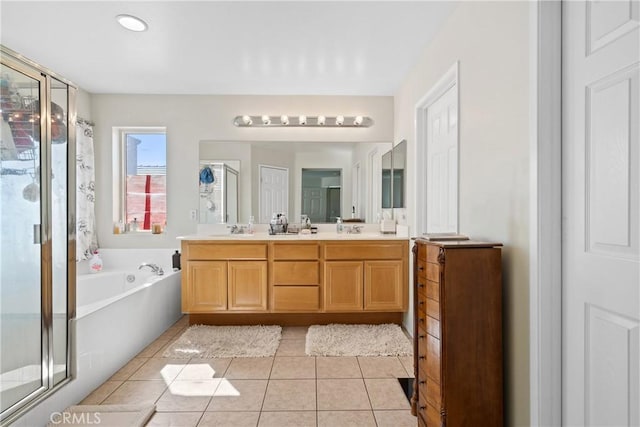 9179 Ravenswood Ave, Hesperia, CA 92344 - bathroom featuring a shower stall, a sink, a bath, double vanity, and tile patterned flooring