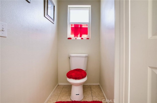 9179 Ravenswood Ave, Hesperia, CA 92344 - bathroom with toilet, tile patterned flooring, and baseboards