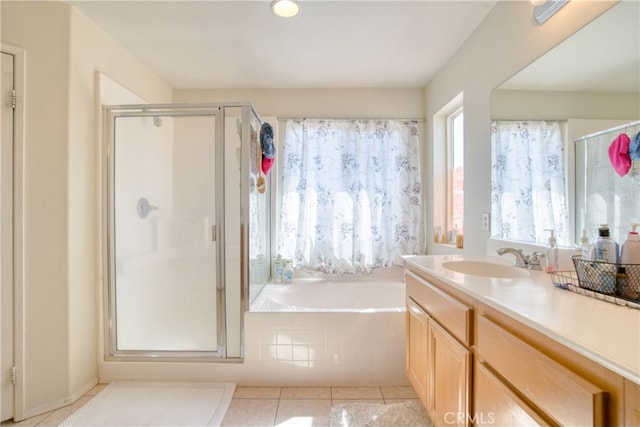 bathroom featuring tile patterned flooring, vanity, and plus walk in shower