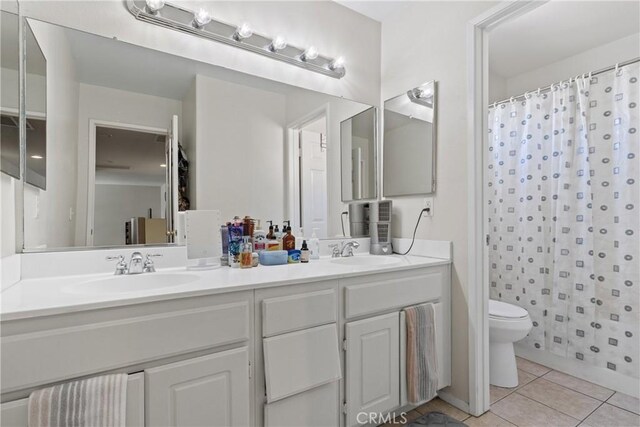 9179 Ravenswood Ave, Hesperia, CA 92344 - bathroom featuring tile patterned flooring, double vanity, toilet, and a sink