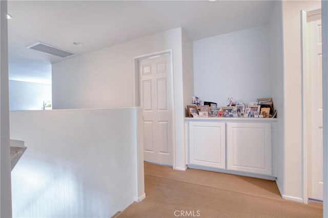 9179 Ravenswood Ave, Hesperia, CA 92344 - hall with light carpet, baseboards, and visible vents