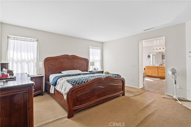 9179 Ravenswood Ave, Hesperia, CA 92344 - bedroom with light carpet, ensuite bath, visible vents, and baseboards