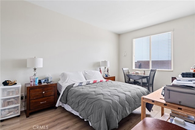 bedroom with wood-type flooring