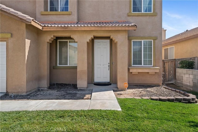 9179 Ravenswood Ave, Hesperia, CA 92344 - entrance to property featuring stucco siding, a tile roof, and fence