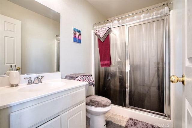 bathroom with tile patterned floors, toilet, walk in shower, and vanity