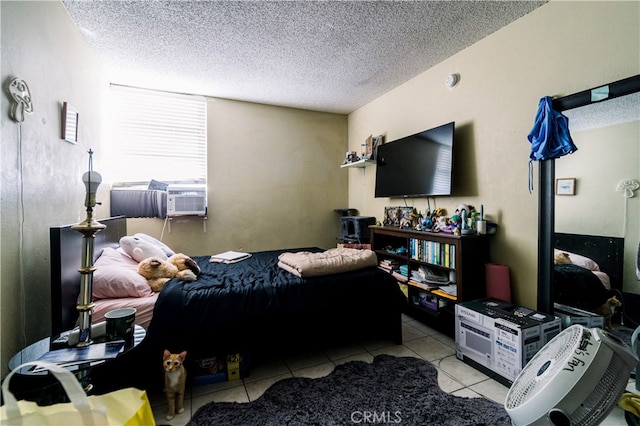 bedroom featuring a textured ceiling and light tile patterned floors