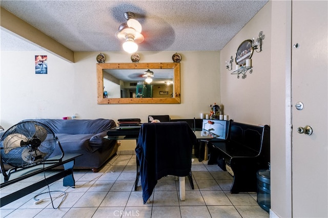 interior space featuring tile patterned flooring, ceiling fan, and a textured ceiling