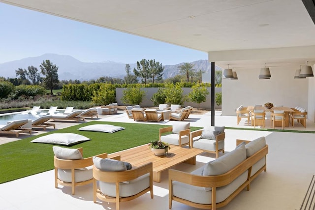 view of home's community with a mountain view and a patio