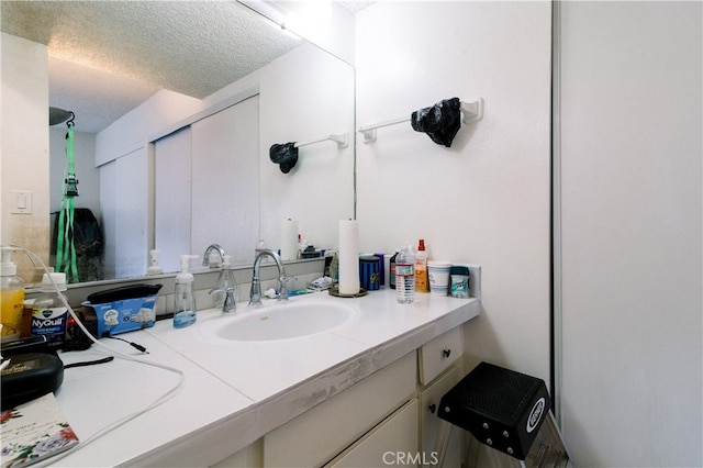 bathroom featuring a textured ceiling and vanity