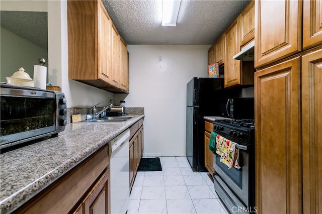 kitchen with a textured ceiling, black appliances, and sink