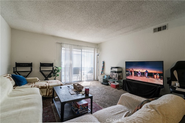 living room with a textured ceiling and carpet