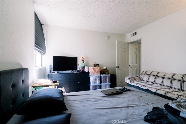 bedroom featuring a textured ceiling