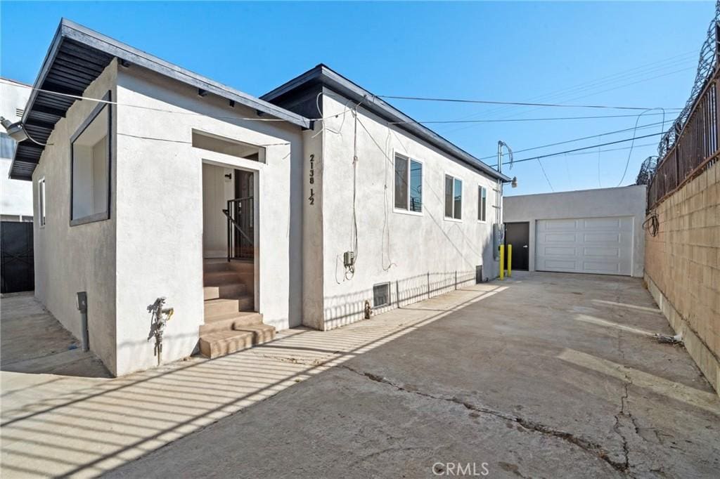 view of side of property with an outbuilding and a garage