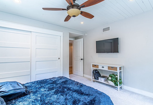 carpeted bedroom with ceiling fan and a closet