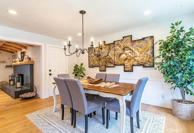 dining space with a notable chandelier and wood-type flooring