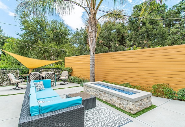 view of patio / terrace featuring an outdoor living space with a fire pit