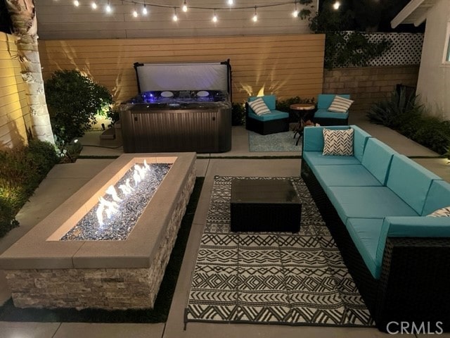 exterior space featuring an outdoor living space with a fire pit