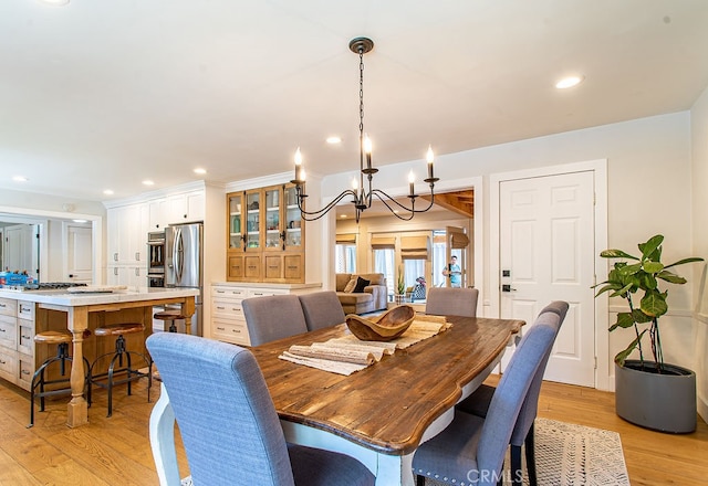 dining room featuring a notable chandelier and light hardwood / wood-style flooring