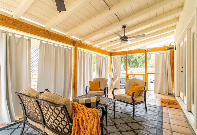 sunroom with lofted ceiling with beams, wood ceiling, and ceiling fan