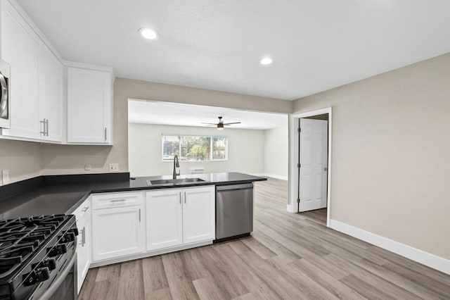 kitchen with appliances with stainless steel finishes, sink, ceiling fan, and white cabinets