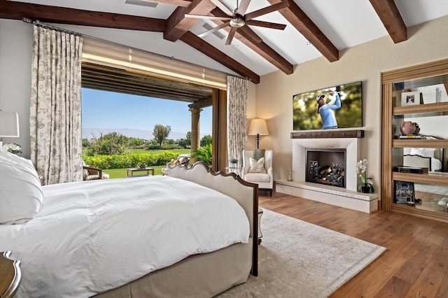 bedroom with wood-type flooring, lofted ceiling with beams, and ceiling fan