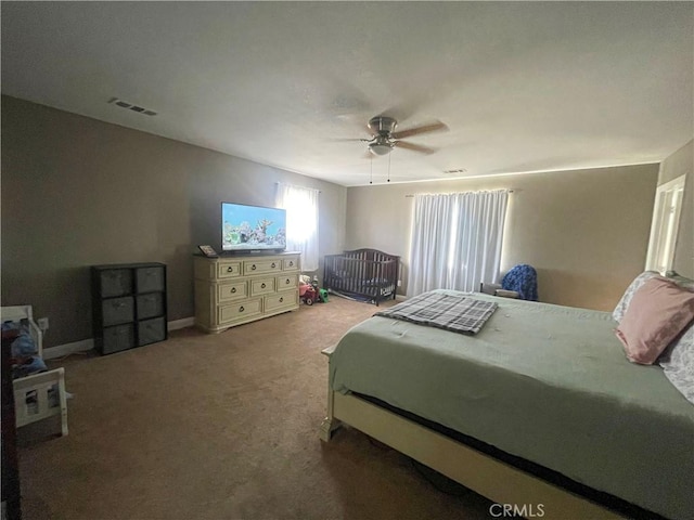 bedroom with ceiling fan, carpet flooring, visible vents, and baseboards