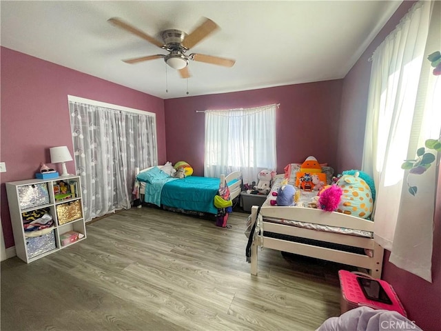 bedroom with ceiling fan and wood finished floors