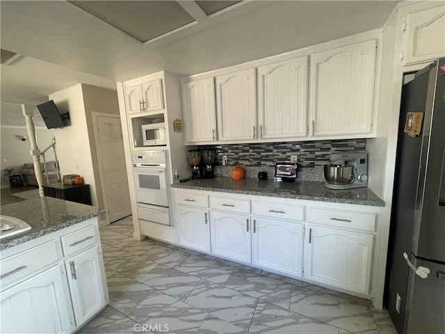 kitchen featuring marble finish floor, white appliances, and white cabinets