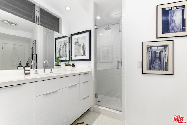 bathroom featuring vanity and a shower with shower door