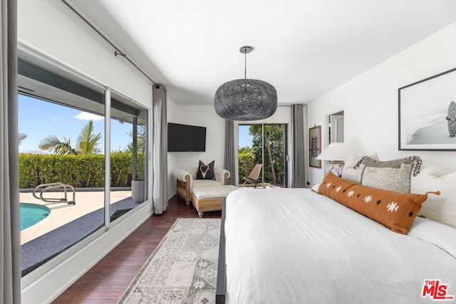 bedroom with dark wood-type flooring and access to exterior