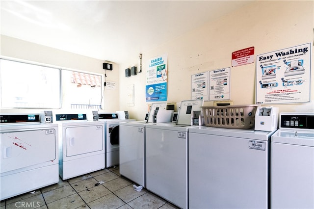 washroom featuring washer and clothes dryer and light tile patterned flooring