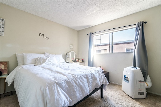 bedroom featuring a textured ceiling and light colored carpet