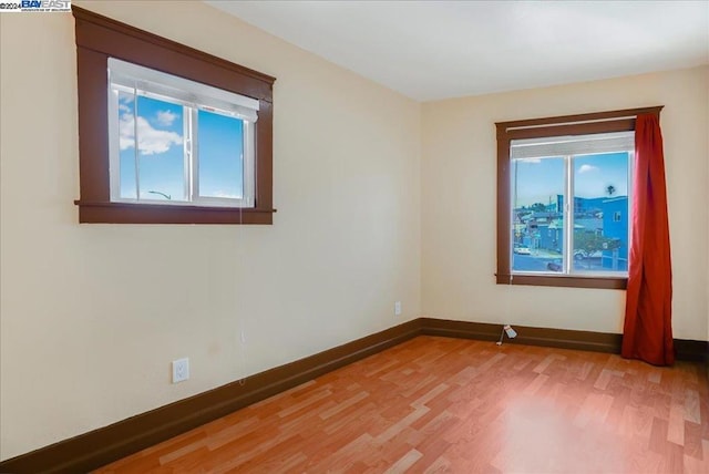 empty room featuring hardwood / wood-style flooring and a wealth of natural light