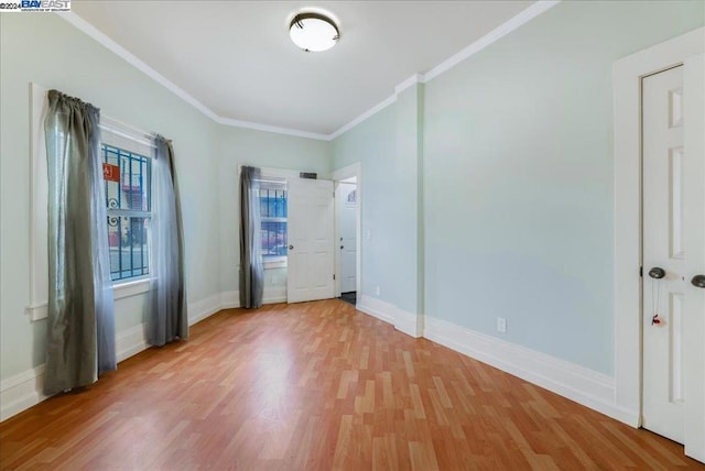 unfurnished bedroom with hardwood / wood-style floors and ornamental molding