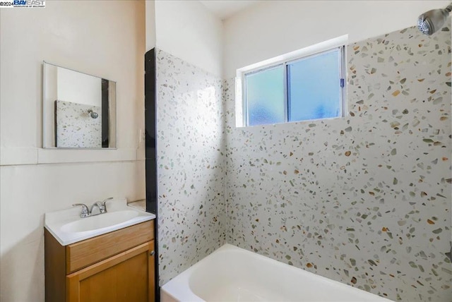 bathroom with shower / bathing tub combination and vanity