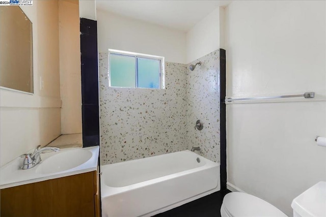 full bathroom with vanity, toilet, and tiled shower / bath