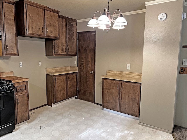 kitchen with black stove, hanging light fixtures, an inviting chandelier, dark brown cabinetry, and crown molding