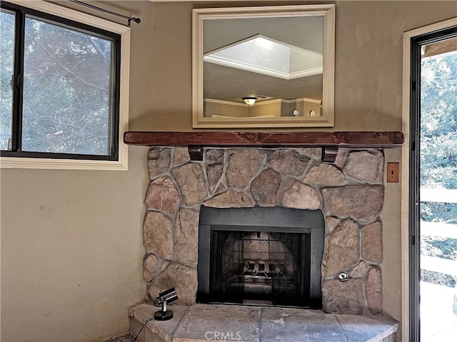 interior details featuring a stone fireplace