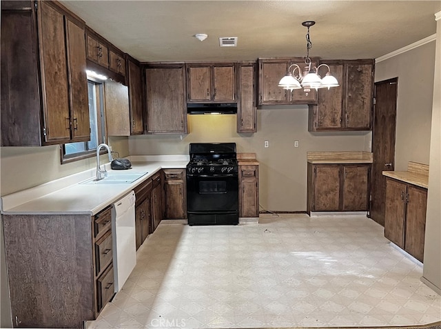 kitchen with hanging light fixtures, dark brown cabinetry, sink, and black gas range