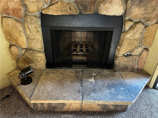 interior details featuring a stone fireplace