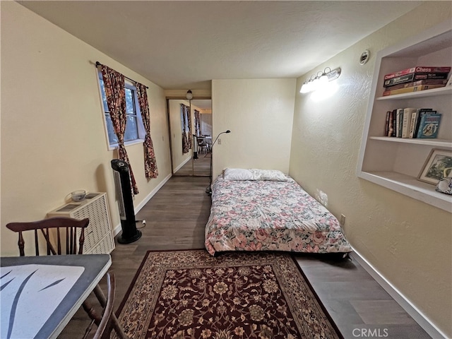 bedroom featuring dark hardwood / wood-style flooring