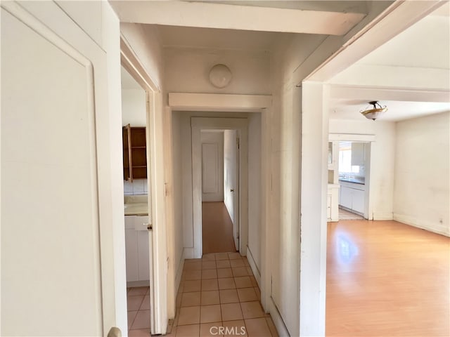 corridor with light hardwood / wood-style floors