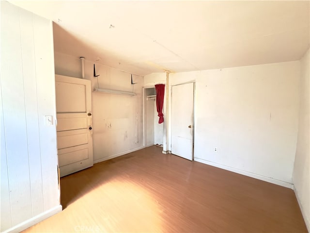 empty room with hardwood / wood-style floors