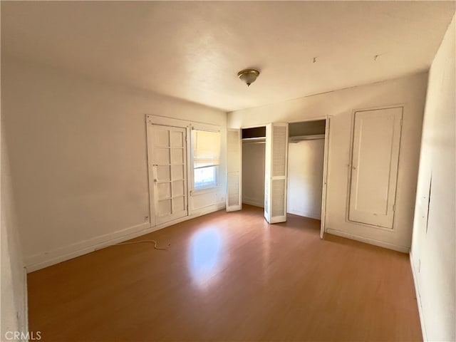 unfurnished bedroom with hardwood / wood-style floors