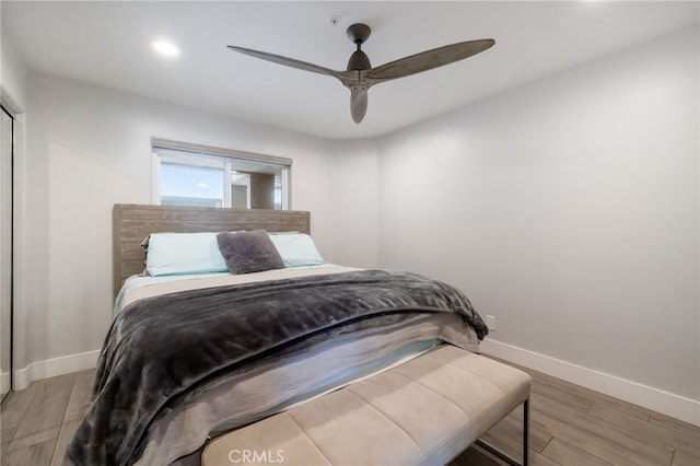 bedroom with ceiling fan and light hardwood / wood-style floors