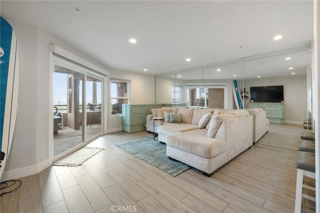 living room with plenty of natural light and light hardwood / wood-style floors